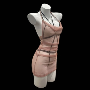 Detail view of pink sheer mesh halter mini dress with black strap accents on mannequin