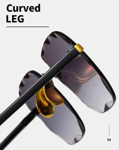 Dettaglio di occhiali da sole senza montura con eleganti stanghette dorate curve