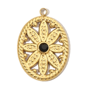 Detail of vintage oval gold steel pendant with black gemstone and floral pattern