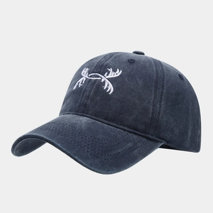 Detail of deer antler embroidery on a navy blue washed cotton baseball cap