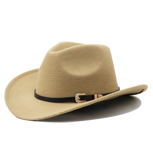 Detail of khaki felt cowboy hat with black leather band and golden engraved buckle