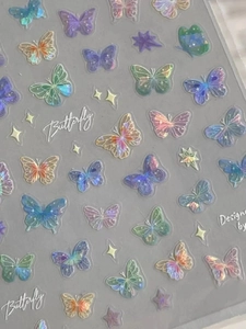 Macro shot of colorful holographic butterfly nail art stickers with shimmering laser effect