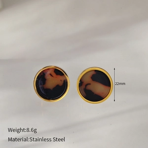 Macro shot of vintage round leopard print earrings in stainless steel with gold edges