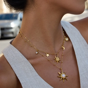 Detail of layered 18K gold stainless steel necklace with opal sun and moon pendants