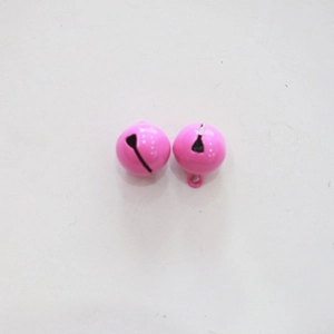 Macro detail of small 14mm pink metal bells for crafts and pet collars