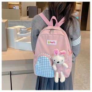 Pink children backpack with blue plaid side pocket and a cute white bunny plush toy hanging