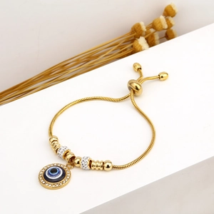 Adjustable golden stainless steel evil eye bracelet with blue stones and crystals