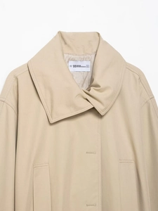 Detailed view of khaki jacket collar featuring woven texture and branded size label