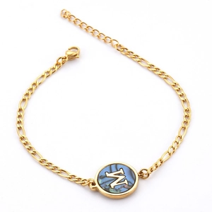 Gold stainless steel bracelet with blue abalone shell M-letter round pendant on white background