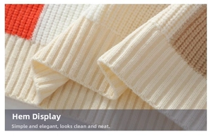 Detailed close-up of ribbed knit hem on a men's color-block warm sweater