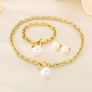 Detailed view of white pearl jewelry set with gold OT clasp necklace, bracelet and earrings