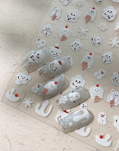 Detailed relief winter nail stickers featuring snowflakes and snowmen on silver glitter nails