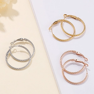 Three-color set of textured stainless steel hoop earrings in gold, silver, and rose gold