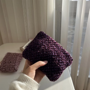 Macro view of purple woven knit texture on a mini pouch with a small simple wish label