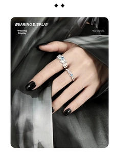 Detail of stacked silver rings with irregular lava texture and blue zircon inlay