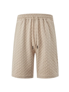 Detail of khaki men's leisure shorts featuring jacquard texture and drawstring waist