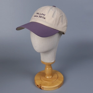 Detail of breathable color-block baseball cap featuring Follow Own Path embroidery