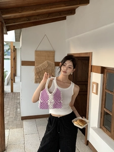 Detailed close-up of handmade purple and white woven tote bag with flower pattern