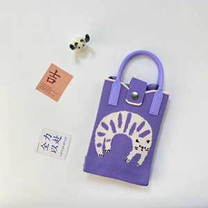 Close-up of purple knitted mobile phone bag with a cute white cat jacquard pattern