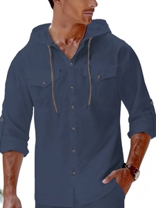 Detail of navy blue linen hooded shirt featuring chest pockets and textured fabric