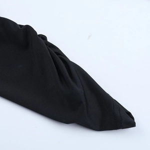 Close-up of the black ribbed fabric texture and fine stitching on the V-neck jumpsuit