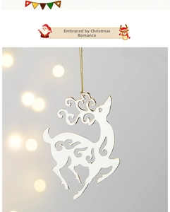 Close-up of white elk ornament with intricate hollow floral patterns and gold string