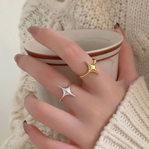 Macro detail of minimalist 925 silver star rings in gold and silver finish