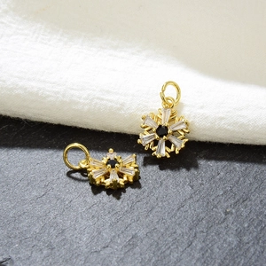 Macro detail of gold snowflake pendants with cubic zirconia for DIY jewelry making