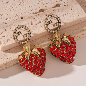 Close-up of vintage strawberry earrings with red crystals and interlocking G logo