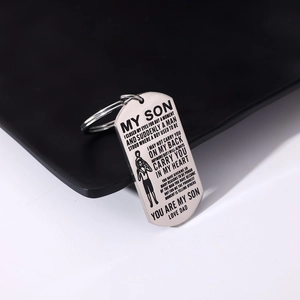 Macro view of stainless steel dog tag keychain with father and son laser engraving
