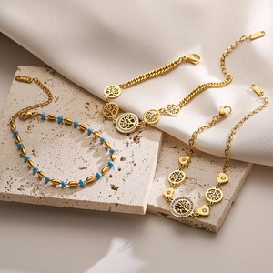 Three-piece gold stainless steel bracelet set featuring Tree of Life and turquoise beads