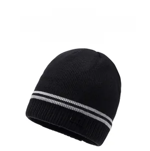 Detailed view of the black knit beanie with gray stripes and FBQE label texture