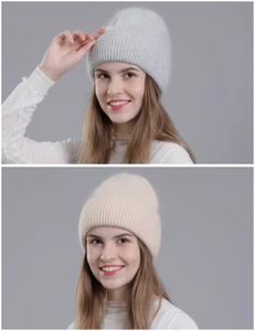 Close-up of soft rabbit fur knit beanie in light grey and beige showing ribbed texture