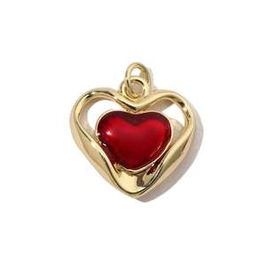 Detailed view of the red heart pendant with a hollow gold-plated frame for jewelry making