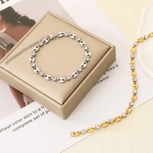 Close-up of gold and silver pig nose link bracelets with pavé cubic zirconia accents