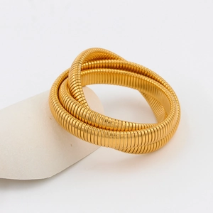Detailed view of three-layer 18K gold-plated snake chain bracelet on a decorative stone