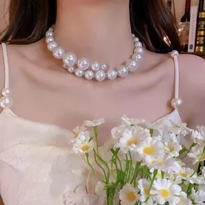 Detail of double-layer spiral pearl necklace with sparkling pavé spacers on a model
