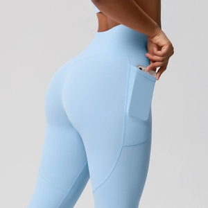 Detail view of high waist yoga pants in light blue featuring a functional side pocket for phone