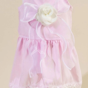 Detail of pink pet dress with white floral ornaments, organza ribbons and lace edges