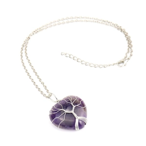 Detailed view of handmade silver wire-wrapped rose quartz heart tree of life necklace