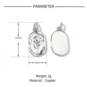 Macro detail of silver rose charm showing dimensions of 21x11mm and material specs