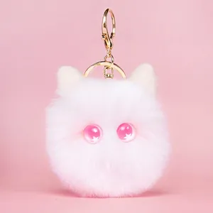 Cute white plush cat keychain with fluffy fur and pink starry eyes on pink background