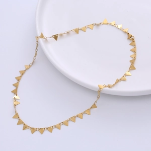 Minimalist stainless steel gold necklace with multiple geometric triangle charms on a tray