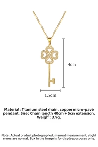 Macro shot of gold clover key pendant necklace with sparkling micro-pave crystals