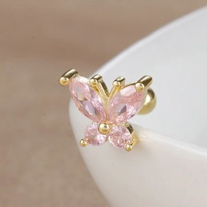 Macro detail of butterfly ear stud with pink marquise zircon and gold screw ball back