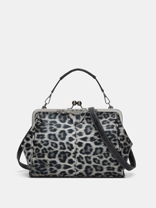 Detail of leopard print kiss-lock handbag with retro silver hardware and black handle