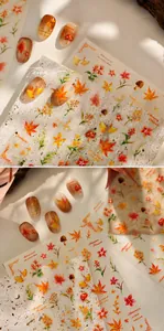 Detail of autumn nail stickers with watercolor maple leaves and mushrooms on clear base