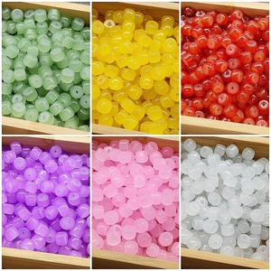 Handcrafted 6x8mm translucent barrel beads in six colors displayed in a wooden box