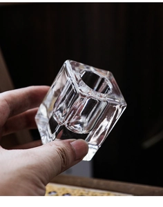 Macro view of clear geometric hexagonal glass candle holder with thick base and high clarity