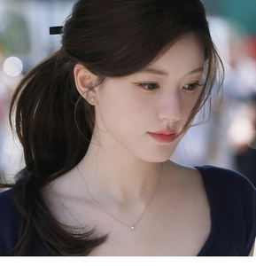 Minimalist silver necklace and stud earrings set with round zircon on female model